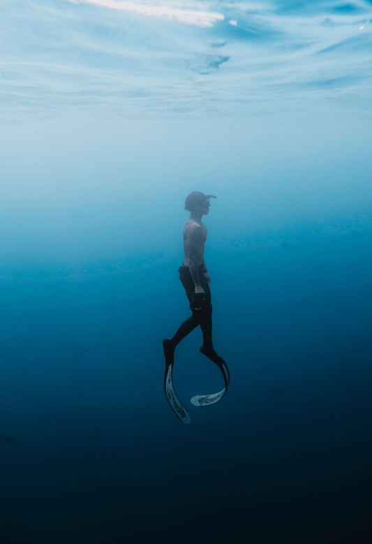 Beginner diver descending underwater during a try scuba diving experience in Bali
