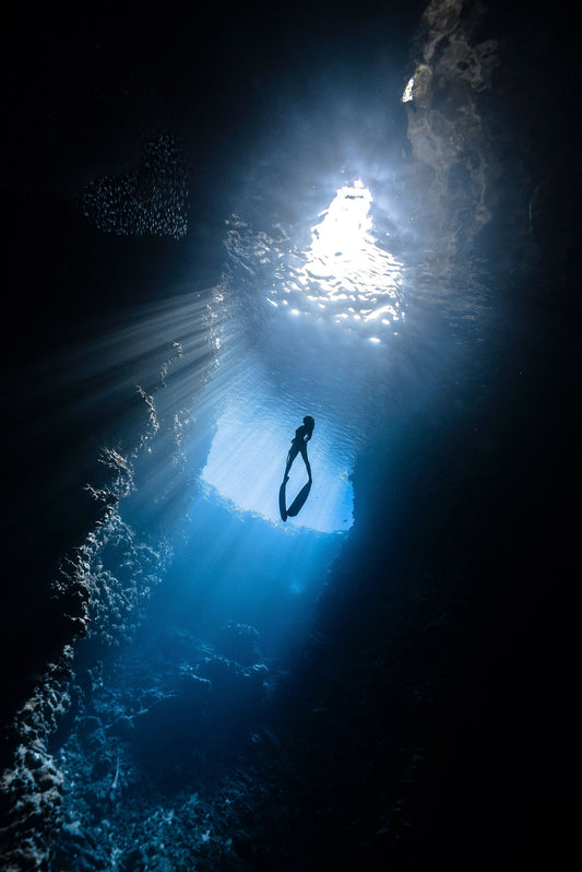 Scuba diver underwater in Bali exploring a coral reef on an all-inclusive dive trip